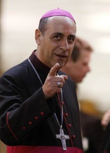 Archbishop Victor Manuel Fernandez, rector of the Catholic University in Argentina, gestures while leaving the concluding session of the extraordinary Synod of Bishops on the family at the Vatican in this Oct. 18 file photo. Archbishop Fernandez served as vice president of the Commission for the Message at the synod. (CNS photo/Paul Haring) See SYNOD-METAPHORS Oct. 8, 2014.
