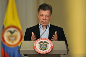 Colombian President Juan Manuel Santos gestures during a joint press conference with former US president and 2002 Nobel peace prize laureate, Jimmy Carter (out of frame) after a meeting on January 12, 2013, at Narino Presidential Palace in Bogota, Colombia. Carter is on a two day visit to Bogota to assess the ongoing peace talks between Colombia's government and its largest leftist guerrilla group, the Revolutionary Armed Forces of Colombia (FARC). This meeting will take place before the government delegation's trip to Havana on Monday to resume talks with FARC's delegation and start the third round of peace negotiations. AFP PHOTO/Guillermo LEGARIA        (Photo credit should read GUILLERMO LEGARIA/AFP/Getty Images)